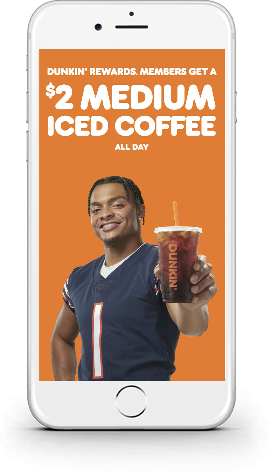 An iphone showing justin fields holding a dunkin coffee